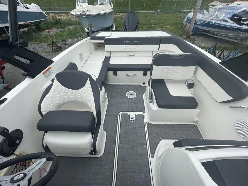 Slide: The Image of 2021 Bayliner VR6 OB boat interior with seating and steering wheel. - 13