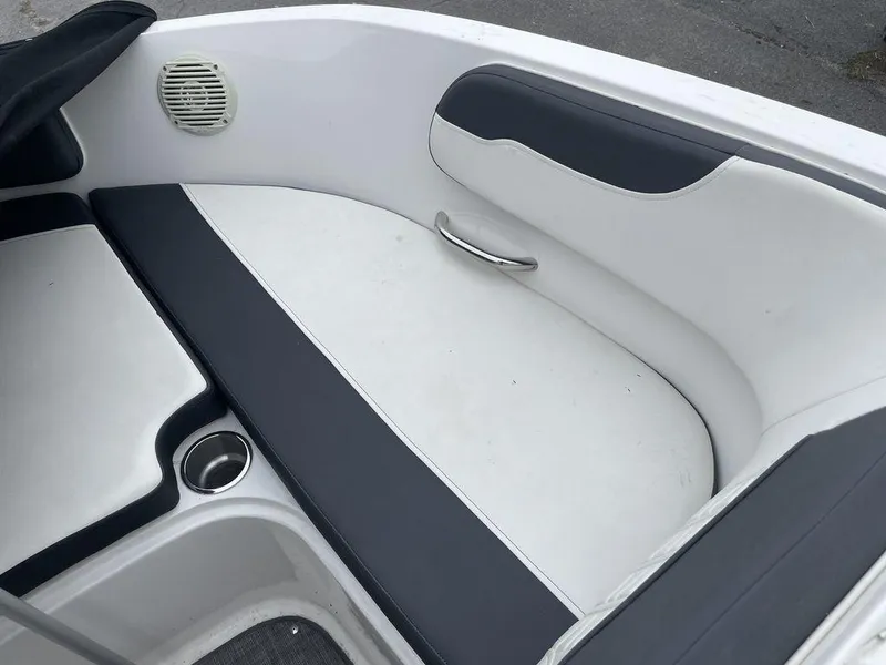 Slide: The Image of 2021 Bayliner VR6 OB boat interior seating with cup holder and speaker. - 14