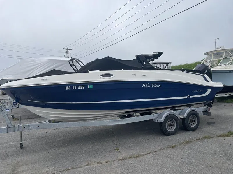 Slide: The Image of 2021 Bayliner VR6 OB boat on a trailer, named Isla View, with a blue and white hull. - 3