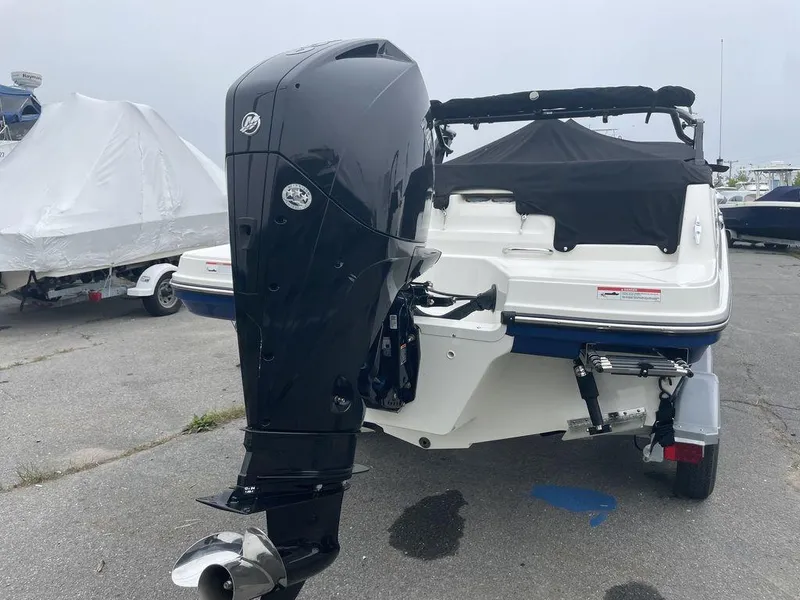 Slide: The Image of 2021 Bayliner VR6 OB boat with outboard motor, docked on a trailer. - 5