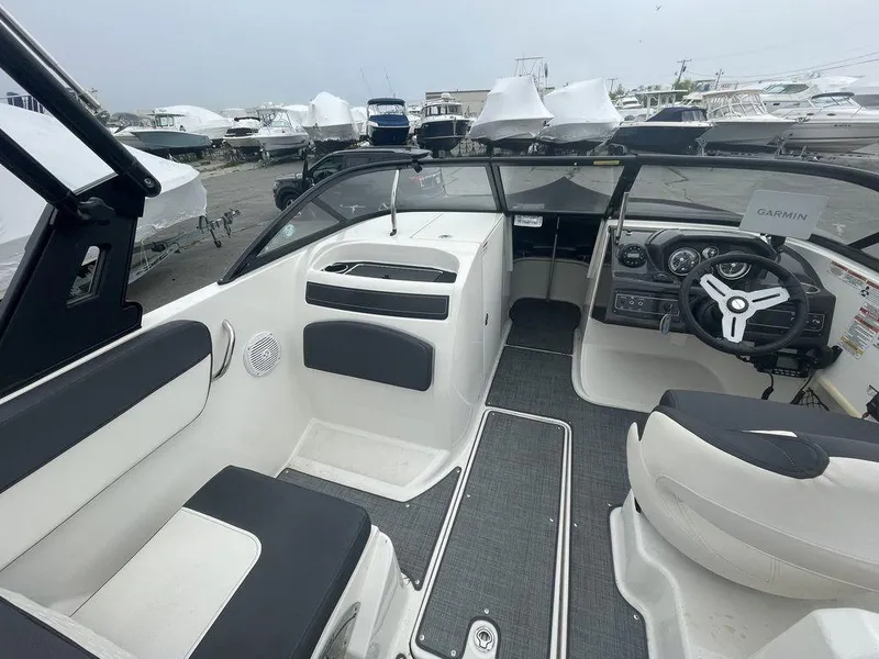 Slide: The Image of 2021 Bayliner VR6 OB boat interior with seating and steering console. - 9