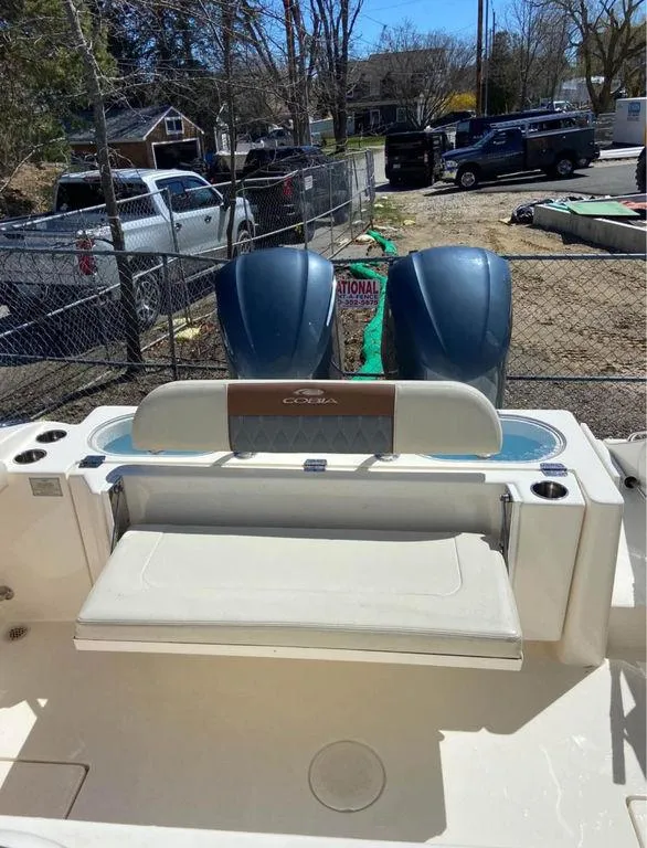 Slide: The Image of 2019 Cobia 301CC boat with dual outboard engines and rear seating. - 7