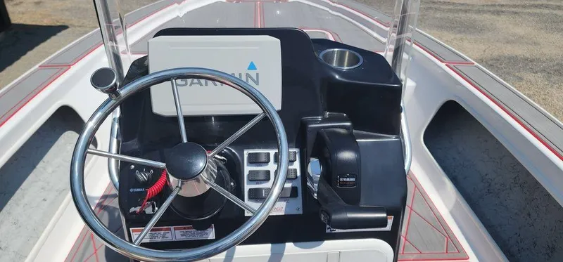 Slide: The Image of 2024 ALK2 Powerboats 17 HS dashboard with steering wheel and controls. - 17