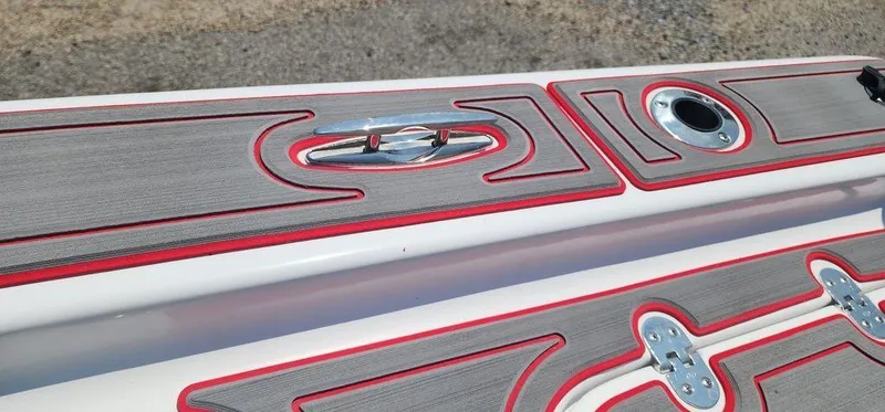 Slide: The Image of 2024 ALK2 Powerboats 17 HS deck with red-trimmed gray panels and metal fixtures. - 24