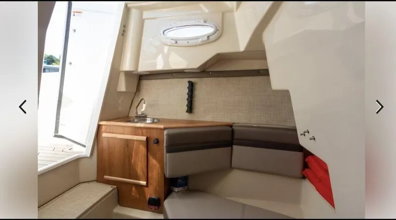 Slide: The Image of 2021 Cutwater C-24W cabin interior with seating and kitchenette. - 10