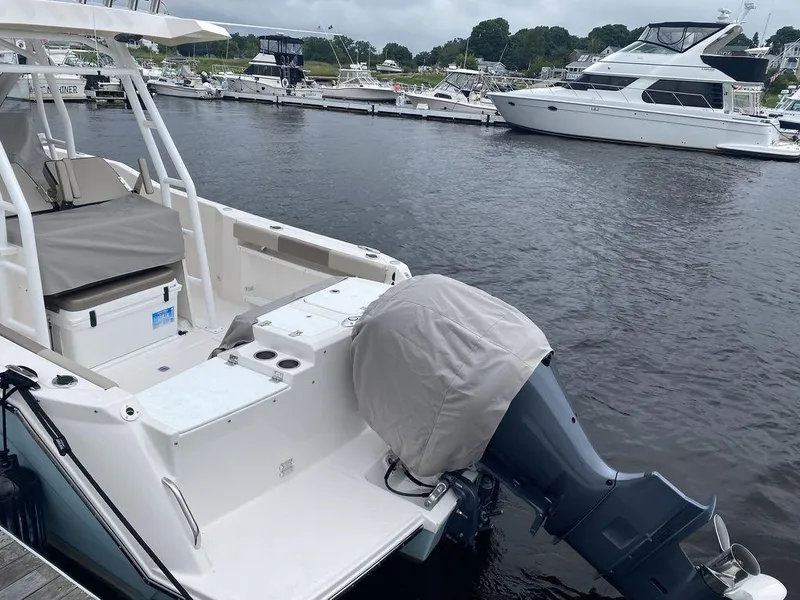 Slide: The Image of 2021 Cutwater C-24W boat docked at marina with covered outboard motor. - 6