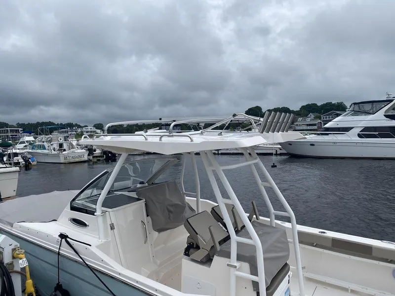 Slide: The Image of 2021 Cutwater C-24W boat docked at marina under cloudy skies. - 7