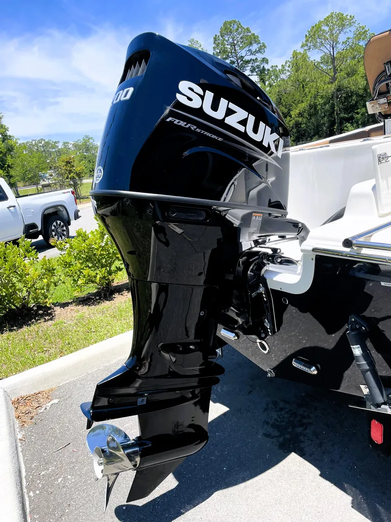 Slide: The Image of 2022 Sea Pro 219 Center Console with Suzuki outboard motor in parking lot. - 19