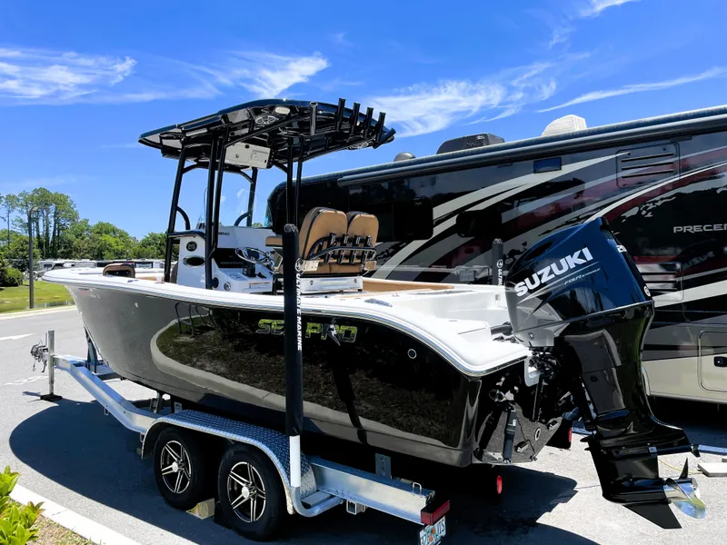 Slide: The Image of 2022 Sea Pro 219 Center Console boat on trailer with Suzuki outboard motor. - 2