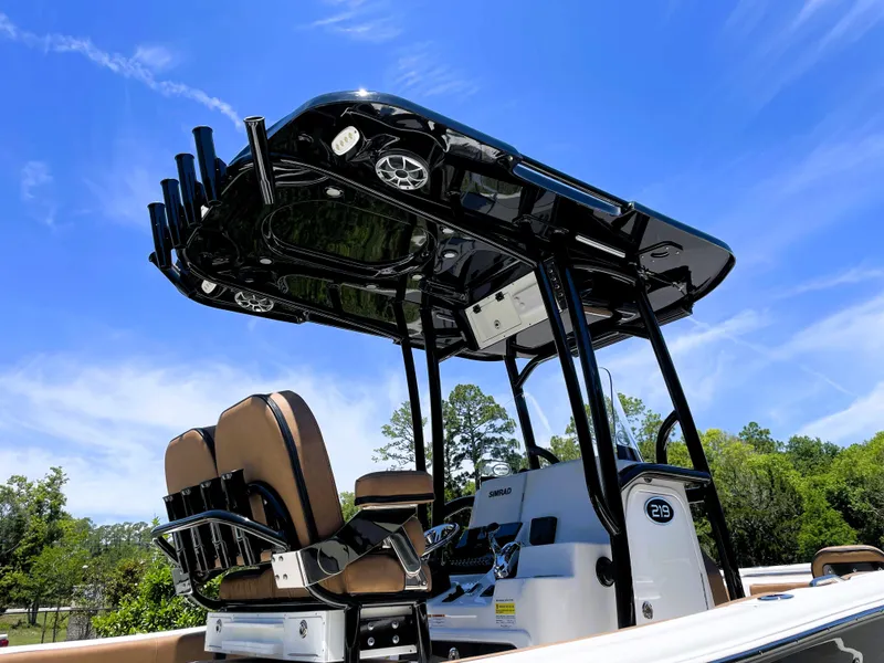 Slide: The Image of 2022 Sea Pro 219 Center Console boat with T-top and seating, under clear blue sky. - 20