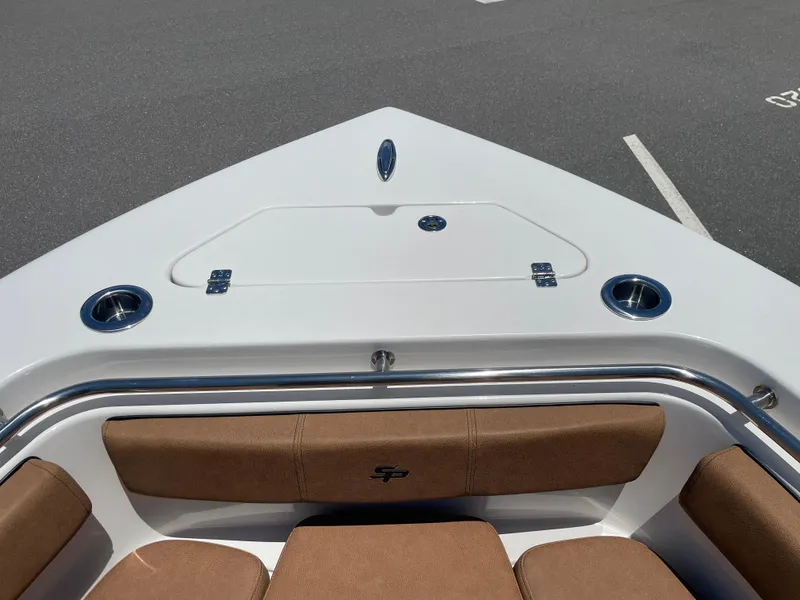 Slide: The Image of 2022 Sea Pro 219 Center Console boat bow with cushioned seating and storage compartment. - 23
