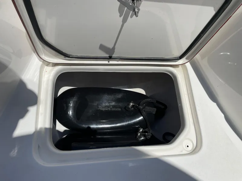 Slide: The Image of Storage compartment of 2022 Sea Pro 219 Center Console boat with black fenders. - 27