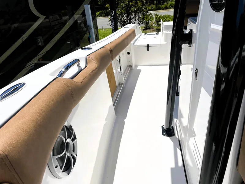 Slide: The Image of 2022 Sea Pro 219 Center Console boat interior with cushioned side rail and speaker. - 30