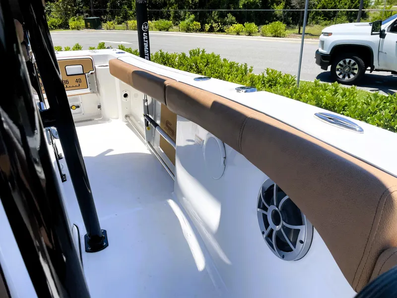 Slide: The Image of 2022 Sea Pro 219 Center Console boat interior with cushioned seating and speaker. - 31