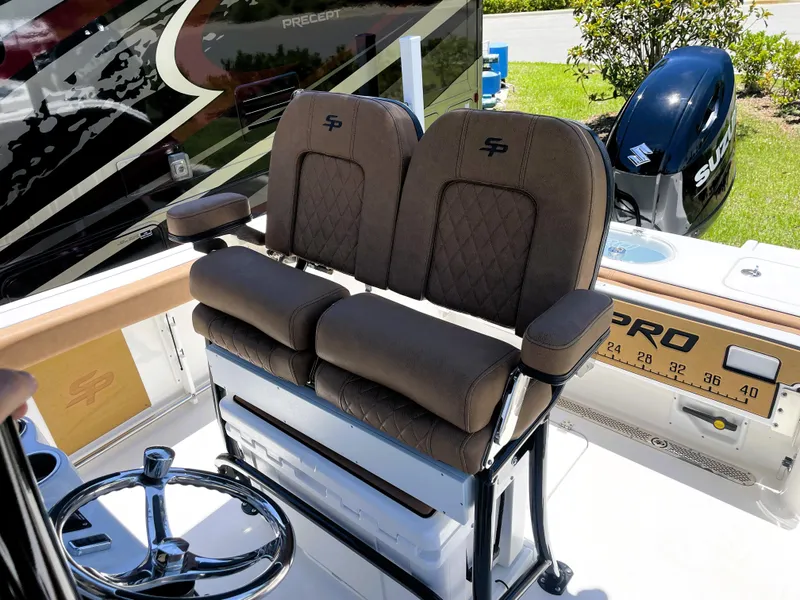 Slide: The Image of 2022 Sea Pro 219 Center Console boat with dual captain's chairs and Suzuki outboard motor. - 34