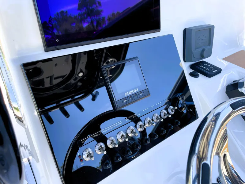 Slide: The Image of 2022 Sea Pro 219 Center Console dashboard with Suzuki display and control panel. - 40