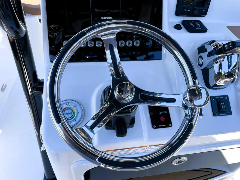 Slide: The Image of 2022 Sea Pro 219 Center Console steering wheel and control panel. - 44