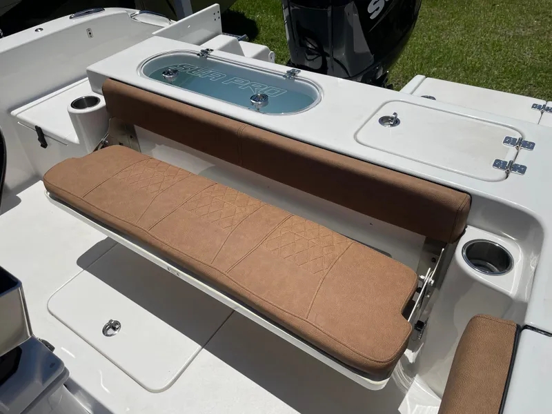 Slide: The Image of 2022 Sea Pro 219 Center Console boat with cushioned seating and storage. - 52