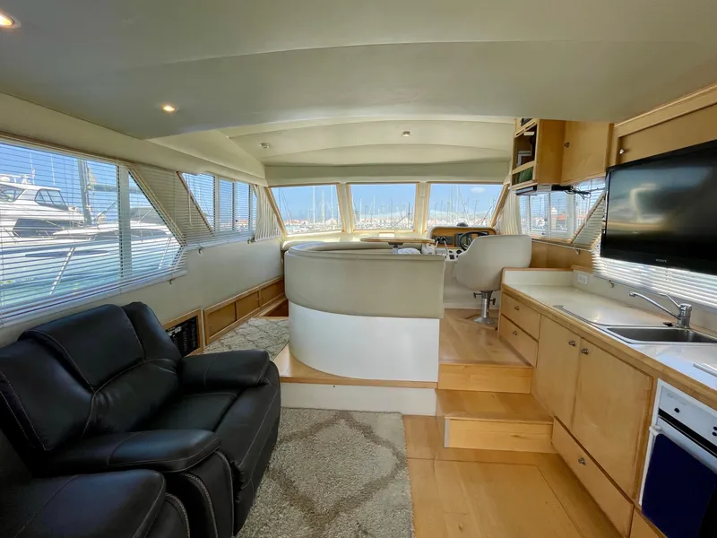 Slide: The Image of Interior of a 1999 Californian 39 yacht with modern furnishings and panoramic windows. - 10