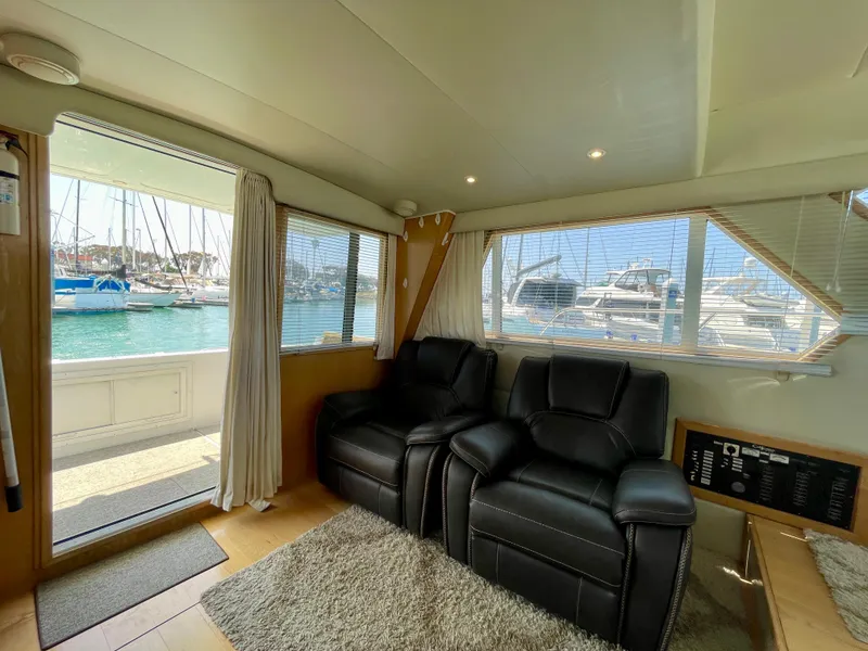 Slide: The Image of Interior of 1999 Californian 39 yacht with leather recliners and marina view. - 13