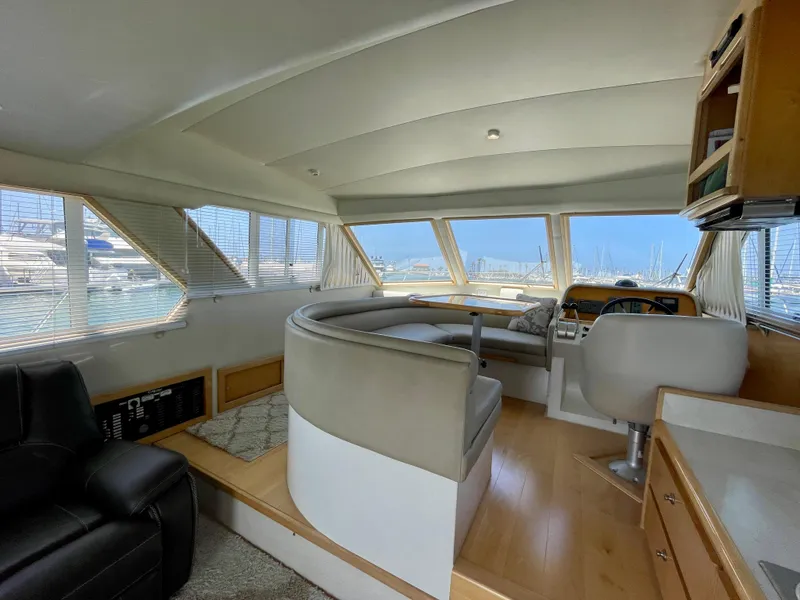 Slide: The Image of Interior of a 1999 Californian 39 yacht with panoramic windows and modern seating. - 15
