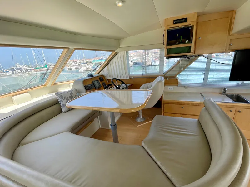 Slide: The Image of Interior of 1999 Californian 39 yacht with panoramic windows and cozy seating area. - 17