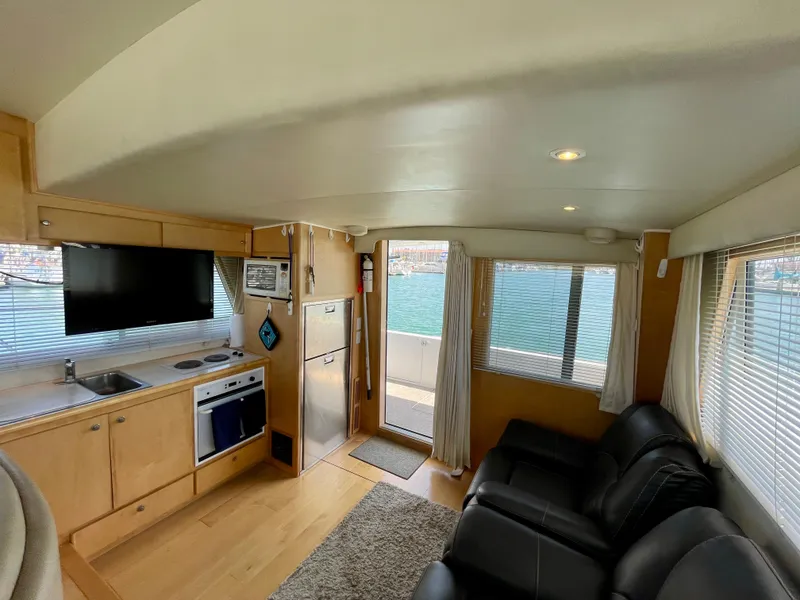 Slide: The Image of Interior of a 1999 Californian 39 yacht with modern kitchen and comfortable seating. - 18