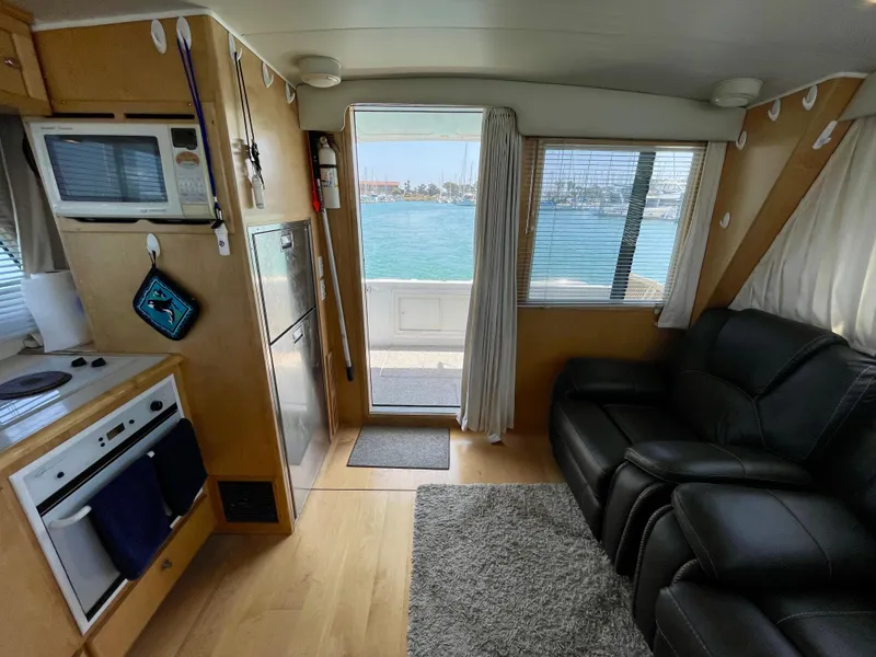 Slide: The Image of Interior of a 1999 Californian 39 boat with kitchen and seating area, ocean view. - 21