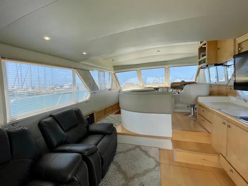 Slide: The Image of Interior of a 1999 Californian 39 yacht with leather seating and panoramic windows. - 24