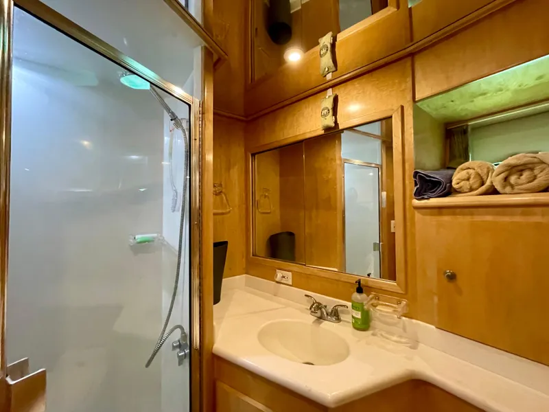Slide: The Image of 1999 Californian 39 yacht bathroom with shower, sink, and wooden cabinetry. - 28