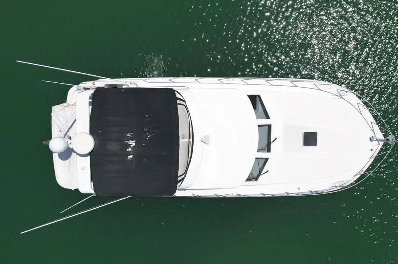 Slide: The Image of Aerial view of a 1999 Californian 39 yacht on green water. - 3