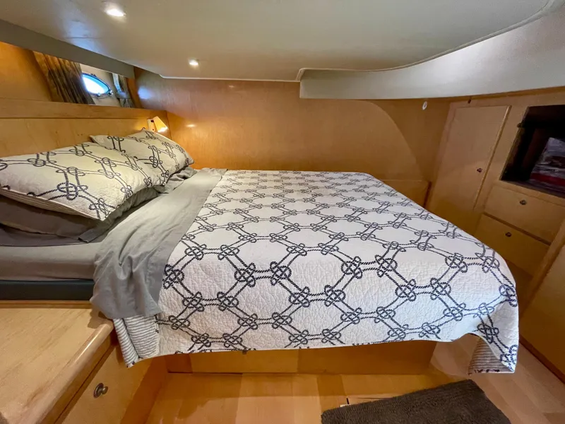 Slide: The Image of Cozy bedroom in a 1999 Californian 39 yacht with a comfortable bed. - 32