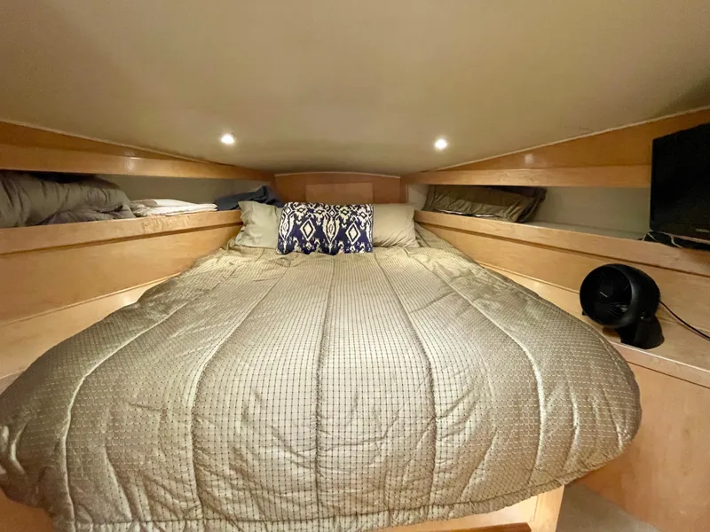 Slide: The Image of Cozy bedroom in a 1999 Californian 39 yacht with a comfortable bed and ambient lighting. - 33