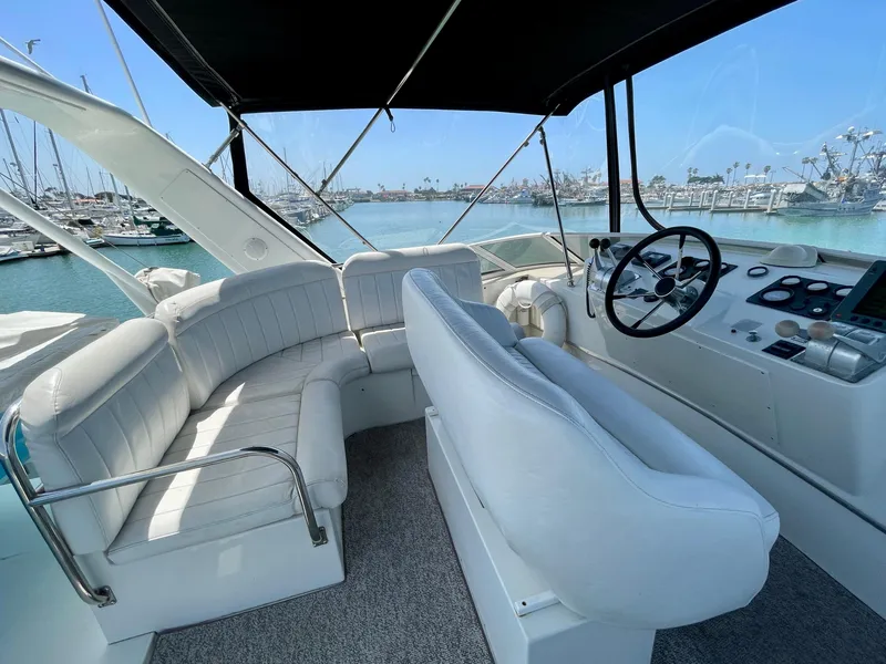 Slide: The Image of 1999 Californian 39 yacht interior with white seating and steering console. - 42
