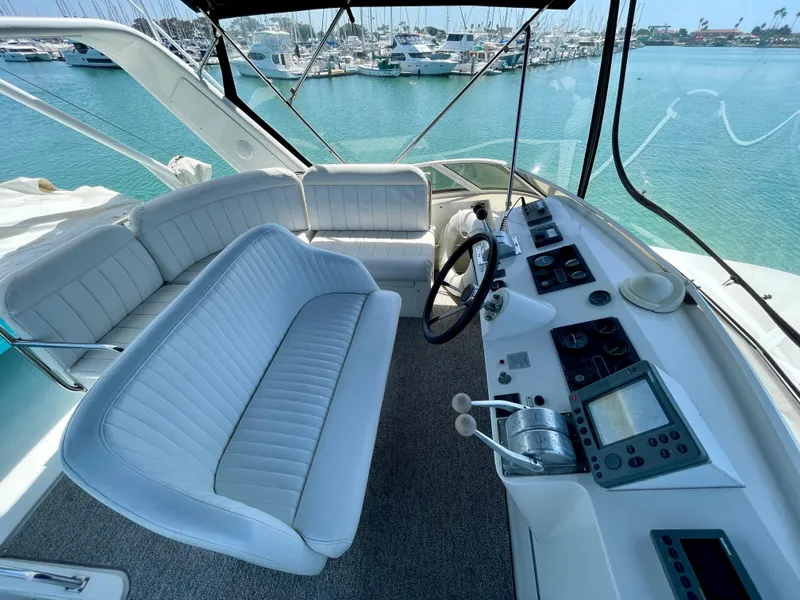 Slide: The Image of 1999 Californian 39 yacht cockpit with white seating and modern navigation equipment. - 46