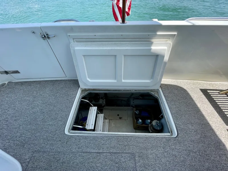 Slide: The Image of Open hatch on 1999 Californian 39 boat revealing storage compartment. - 48
