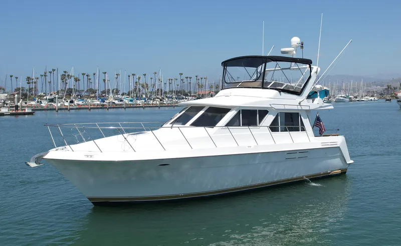 Slide: The Image of 1999 Californian 39 yacht cruising in a marina with palm trees in the background. - 5