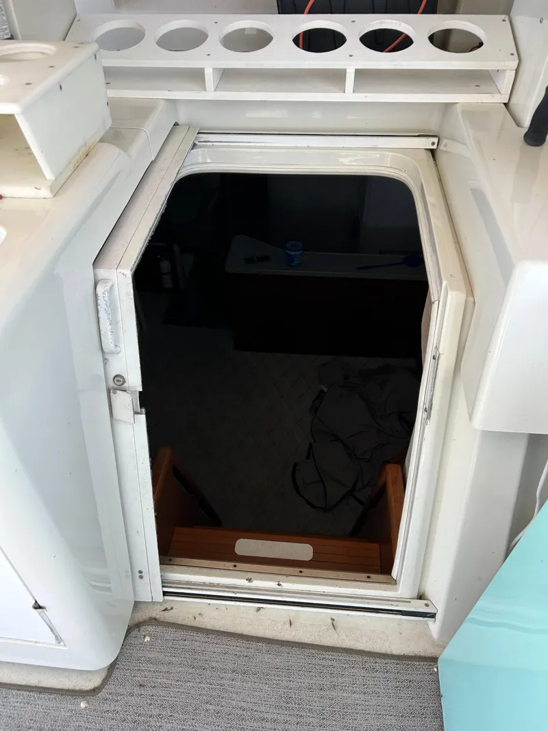 Slide: The Image of 1995 Silverton AFT CABIN boat interior entrance with steps and storage compartments. - 10