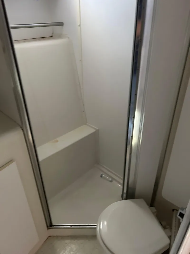 Slide: The Image of 1995 Silverton AFT CABIN bathroom with shower and toilet. - 18