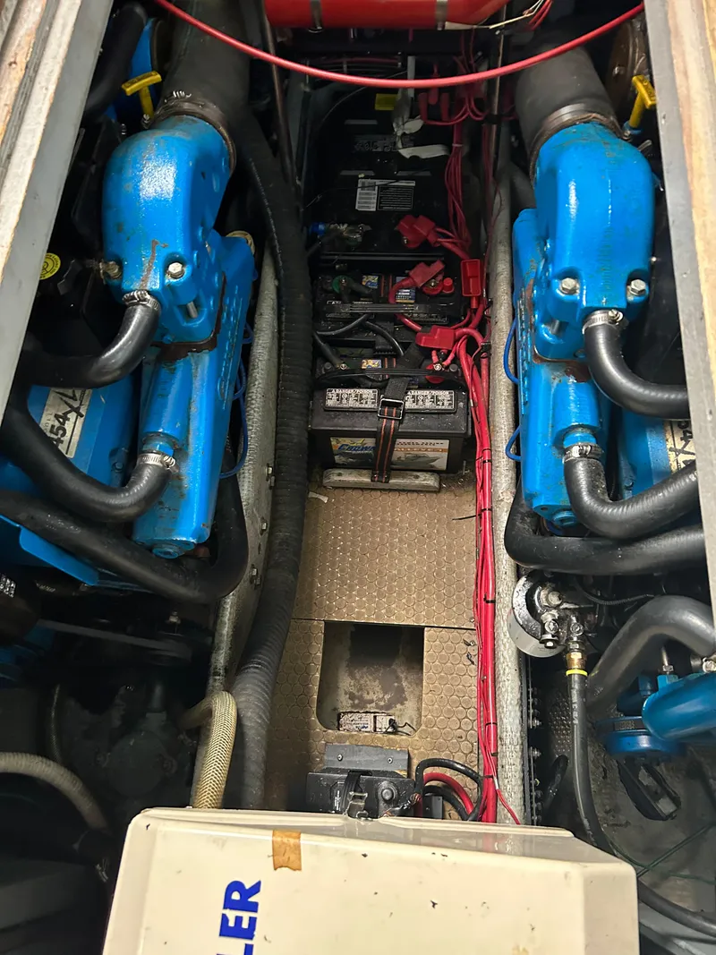 Slide: The Image of Engine compartment of a 1995 Silverton AFT CABIN boat with dual blue engines. - 21