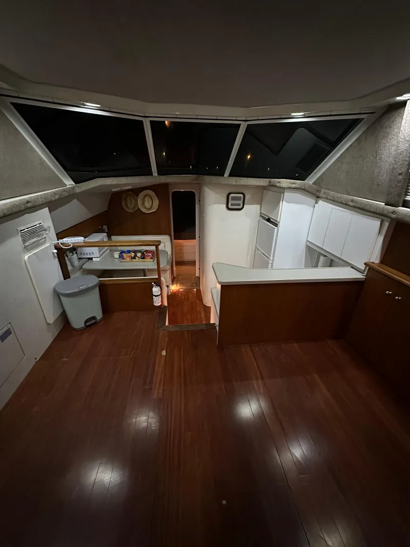 Slide: The Image of 1995 Silverton AFT CABIN interior with wood flooring and kitchenette. - 6