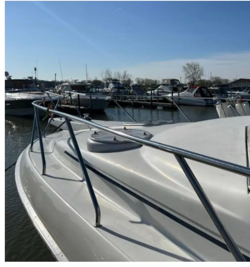 Slide: The Image of 1995 Silverton AFT CABIN boat docked at a marina under clear blue skies. - 8