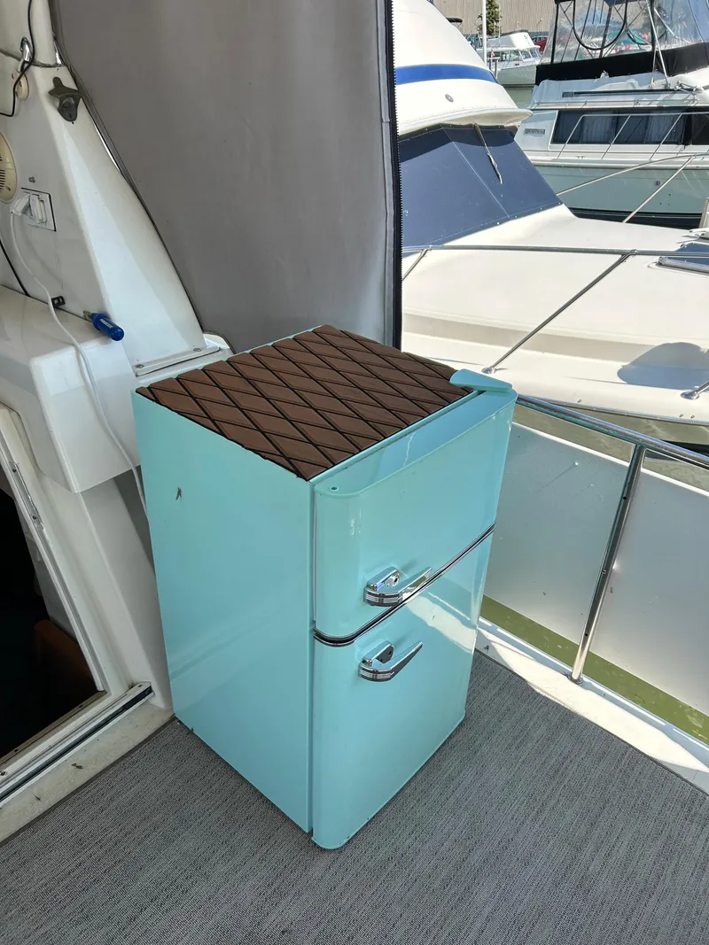 Slide: The Image of 1995 Silverton AFT CABIN yacht interior with vintage-style blue fridge. - 9