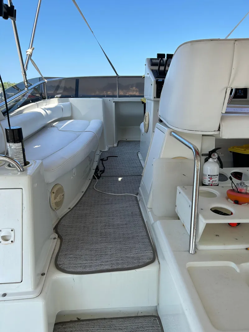 Slide: The Image of 1995 Silverton AFT CABIN boat interior with seating and storage, featuring a clean, white design. - 13