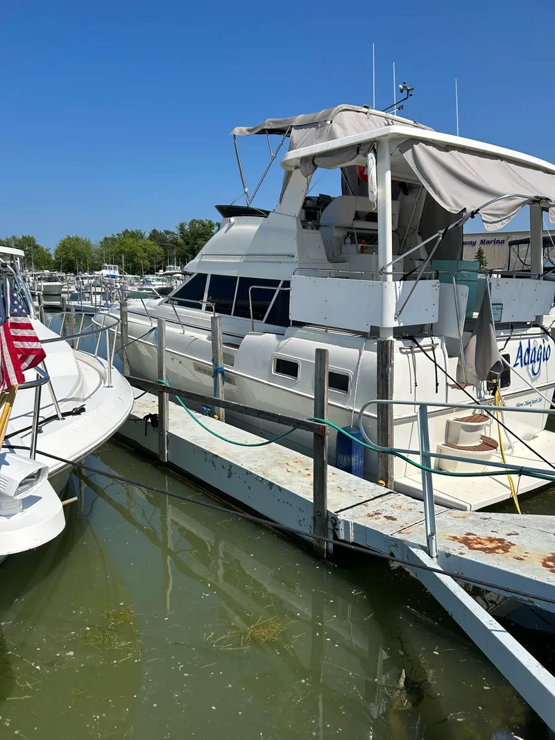 Slide: The Image of 1995 Silverton AFT CABIN yacht docked at marina under clear blue sky. - 14