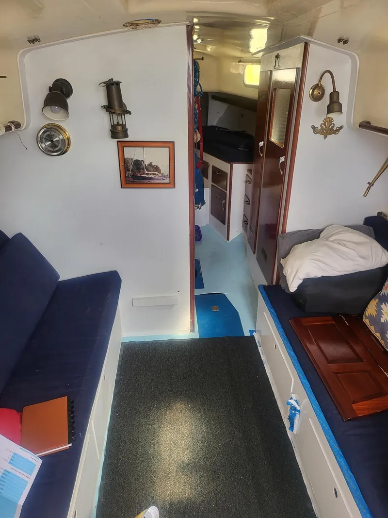 Slide: The Image of Interior of a 1960 Rhodes Bounty II sailboat with cozy seating and nautical decor. - 3