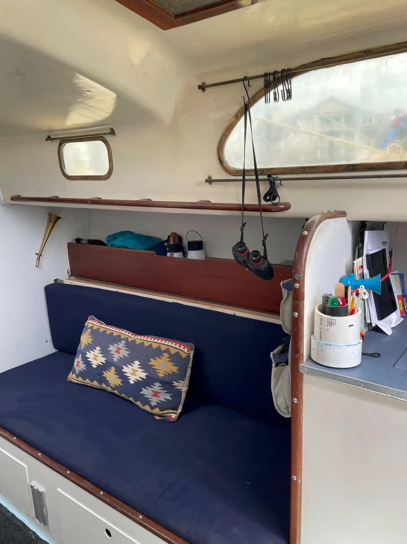 Slide: The Image of Interior of a 1960 Rhodes Bounty II sailboat with cozy seating and nautical decor. - 9