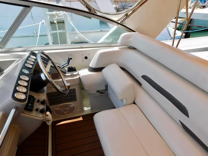 Slide: The Image of 1999 Formula 41 Performance Cruiser cockpit with white leather seating and control panel. - 12