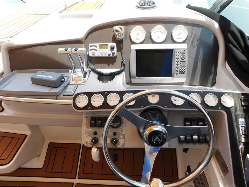 Slide: The Image of 1999 Formula 41 Performance Cruiser helm with navigation instruments and teak flooring. - 13
