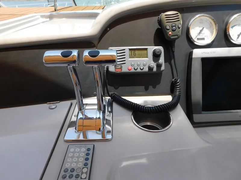 Slide: The Image of Control panel of a 1999 Formula 41 Performance Cruiser boat with throttle levers and communication equipment. - 14
